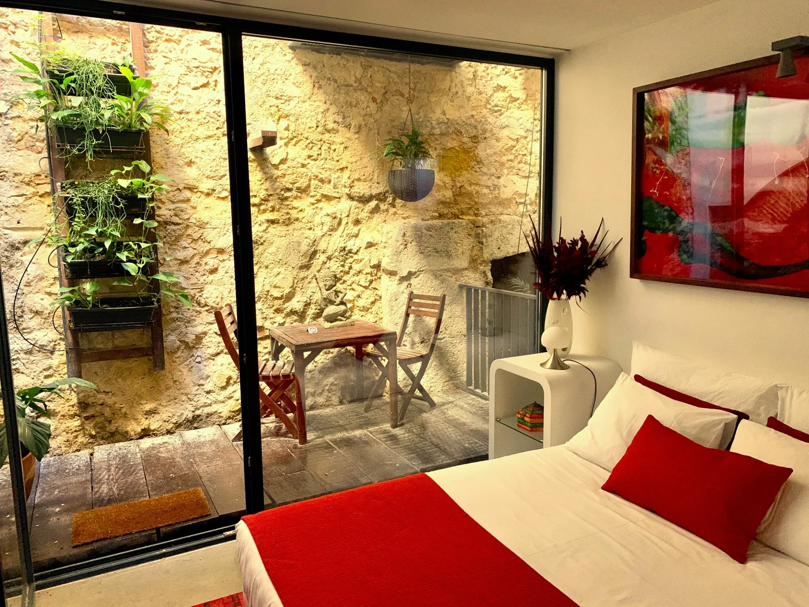 Bedroom opening onto the patio at Old Red Stable in Chiado